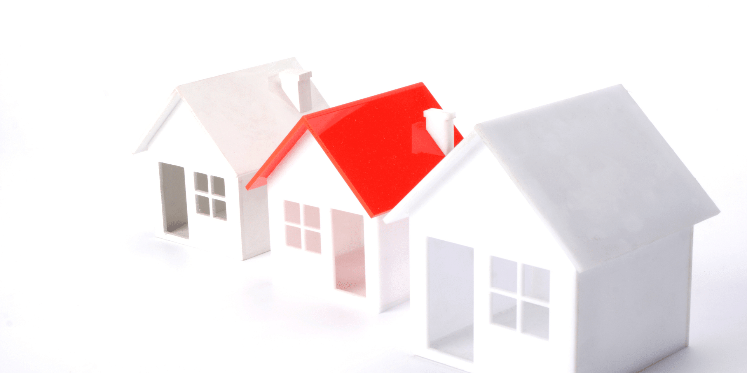 LJHHL Blog_Cash Rate Update _June 2026 Paper houses model with a red-roofed house among white structures on a white background.